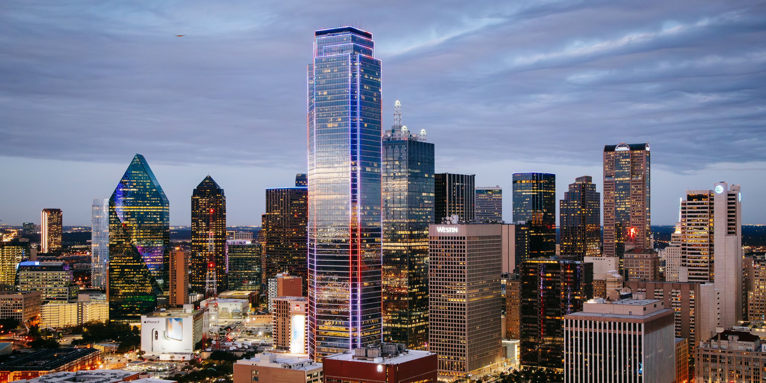 City skyline at dusk with illuminated buildings