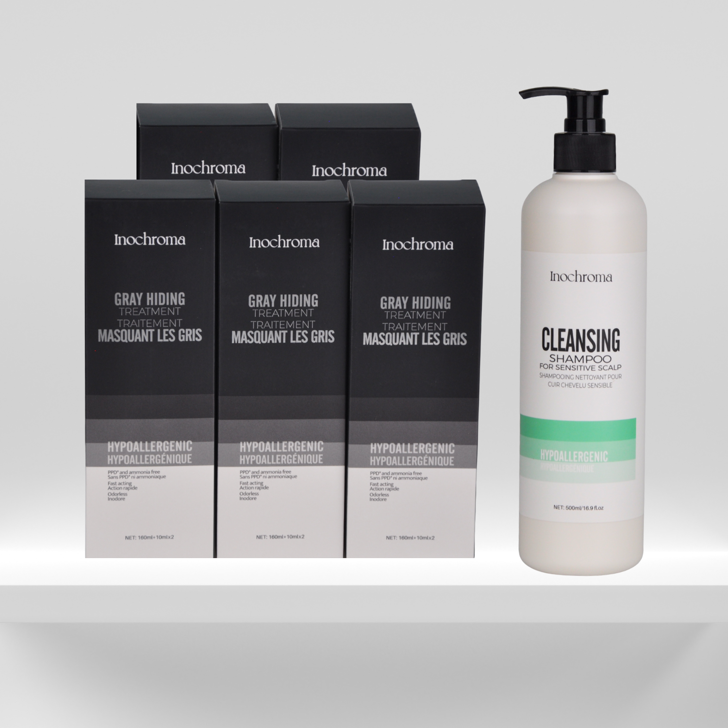 Inochrome hair care products including boxes and a bottle on a light gray background