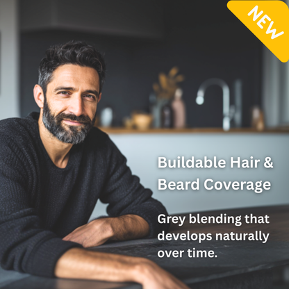 Man with a beard in a kitchen setting, promoting buildable hair and beard coverage.