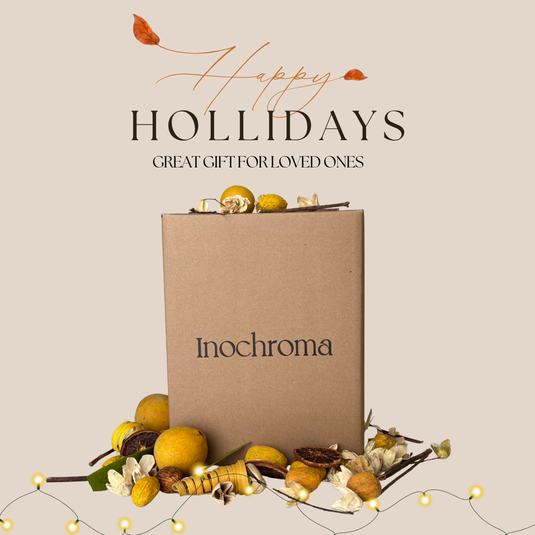 Gift box with 'Inochroma' branding and holiday decorations on a beige background